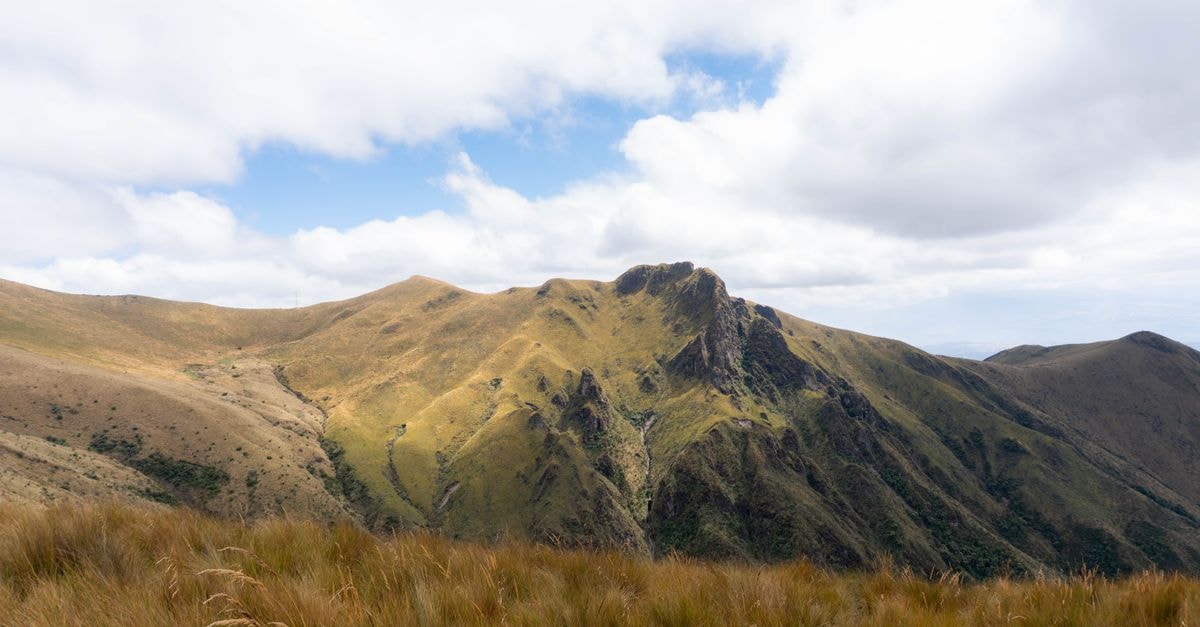 Visiting Macas: a slow travel guide to Ecuador's forested Andean capital A stunning view of the Andean mountains under a vibrant sky in Quito, Ecuador.