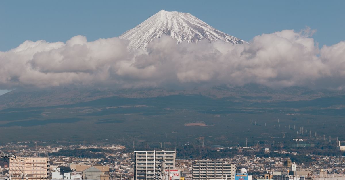 Shizutetsu Hotel Prezio in Shizuoka: 2-Minute Walk from JR Shizuoka Station Scenic view of Mount Fuji surrounded by clouds with a cityscape in Shizuoka, Japan.