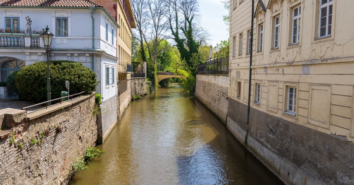 Pardubice travel guide: an unhurried Czech city by the river Charming view of a canal in Prague's old town with historic buildings and lush greenery.