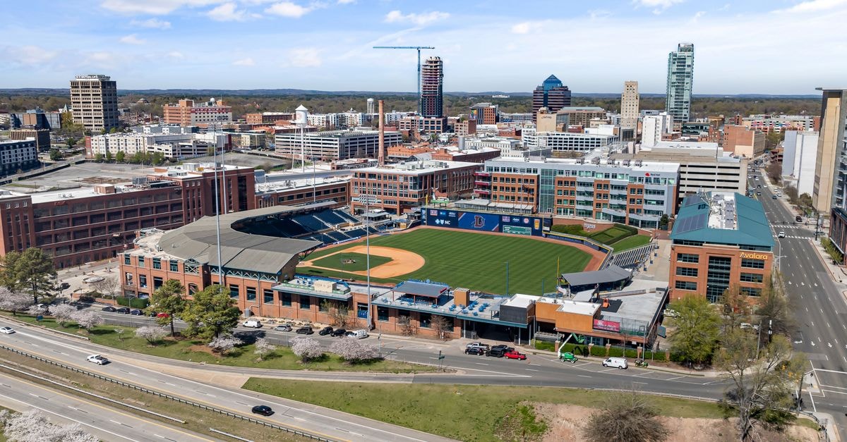 Durham Marriott City Center in Durham, NC: Steps from the Carolina Theatre Aerial shot of Durham Bulls Athletic Park with city skyline in springtime.