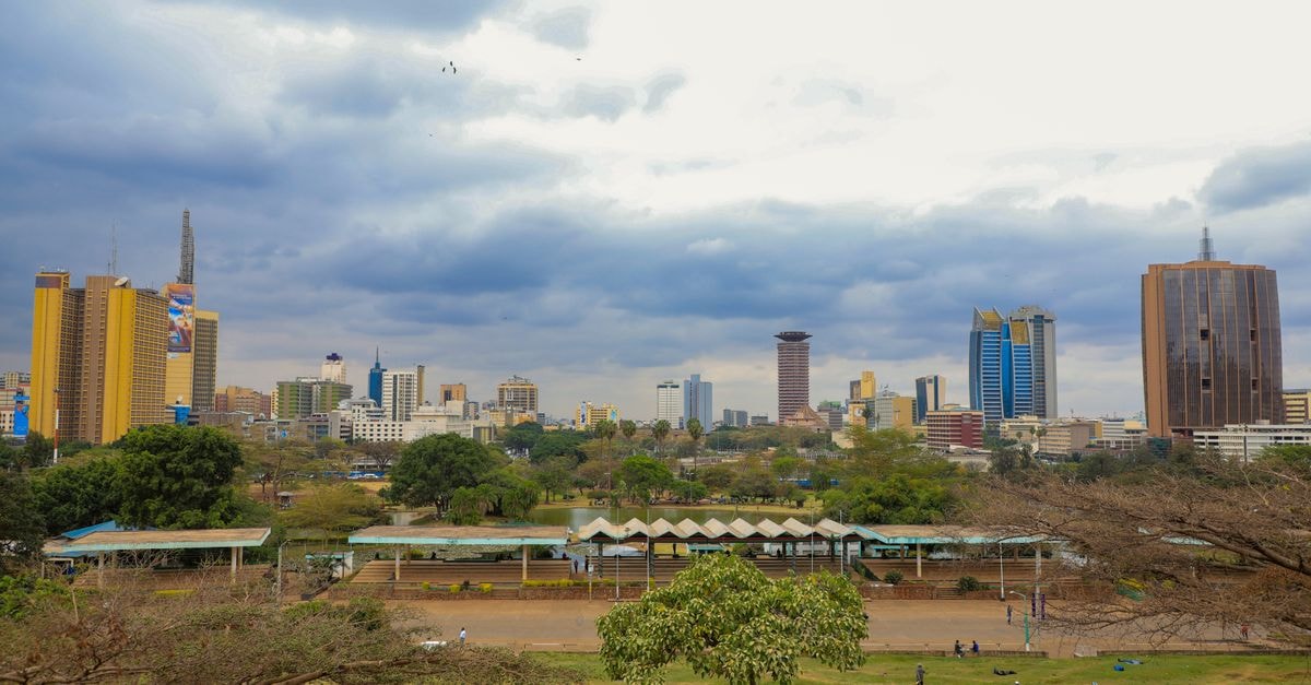 Mayhouse 680 Hotel in Nairobi: 120 Refurbished Rooms on Kenyatta Avenue Scenic skyline view of Nairobi cityscape with iconic skyscrapers and lush greenery.