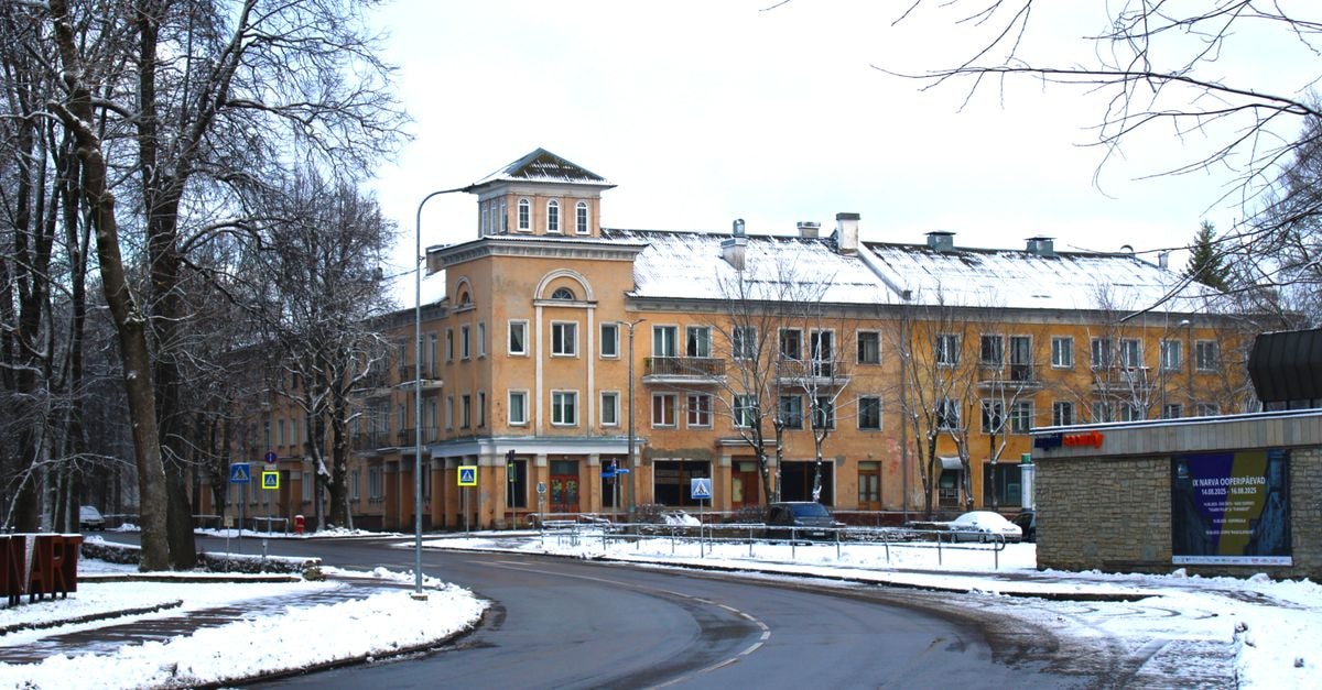 Snow-covered street in Narva, Estonia, featuring historic buildings and urban winter scenery.