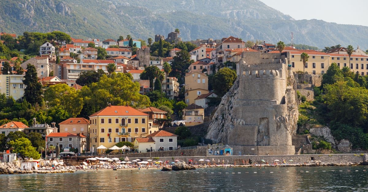Hunguest Hotel Sun Resort, Herceg Novi — Adriatic Seafront Stay Breathtaking view of Herceg Novi featuring the Kanli Kula Fortress and vibrant coastline.