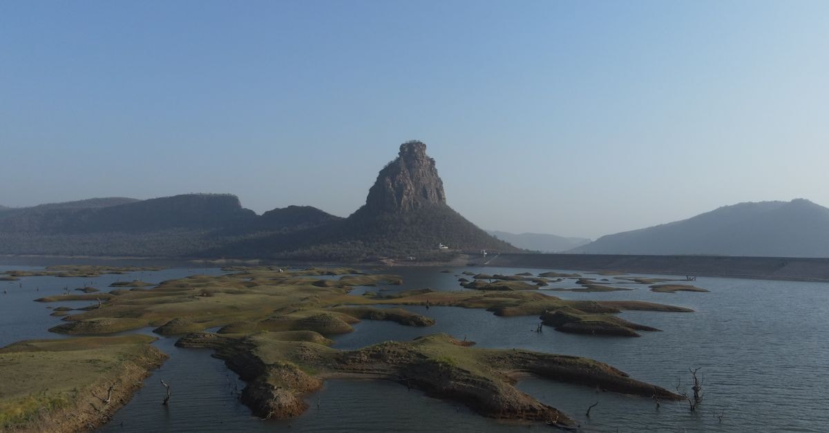 Kurnool Travel Guide: Heritage Stones and River-Town Calm A breathtaking view of a rugged island and clear sky in Karamchat, India. Ideal for nature enthusiasts.