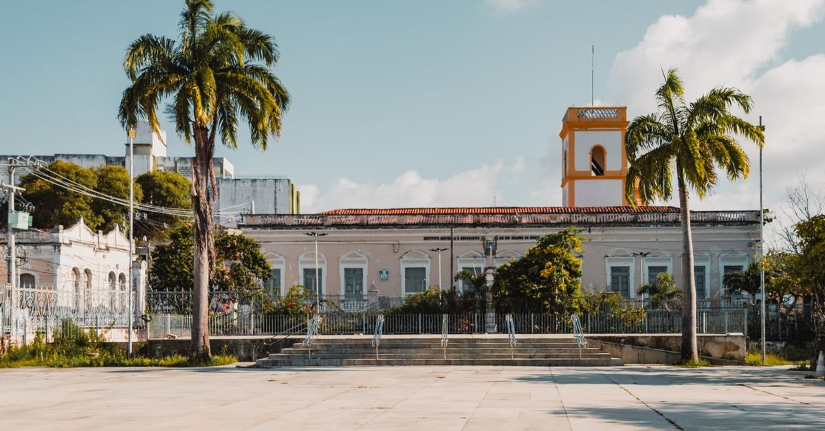 Arauca Travel Guide: Planning Tips, Costs and Things to Do An elegant historic building with palm trees in Natal, Brazil.