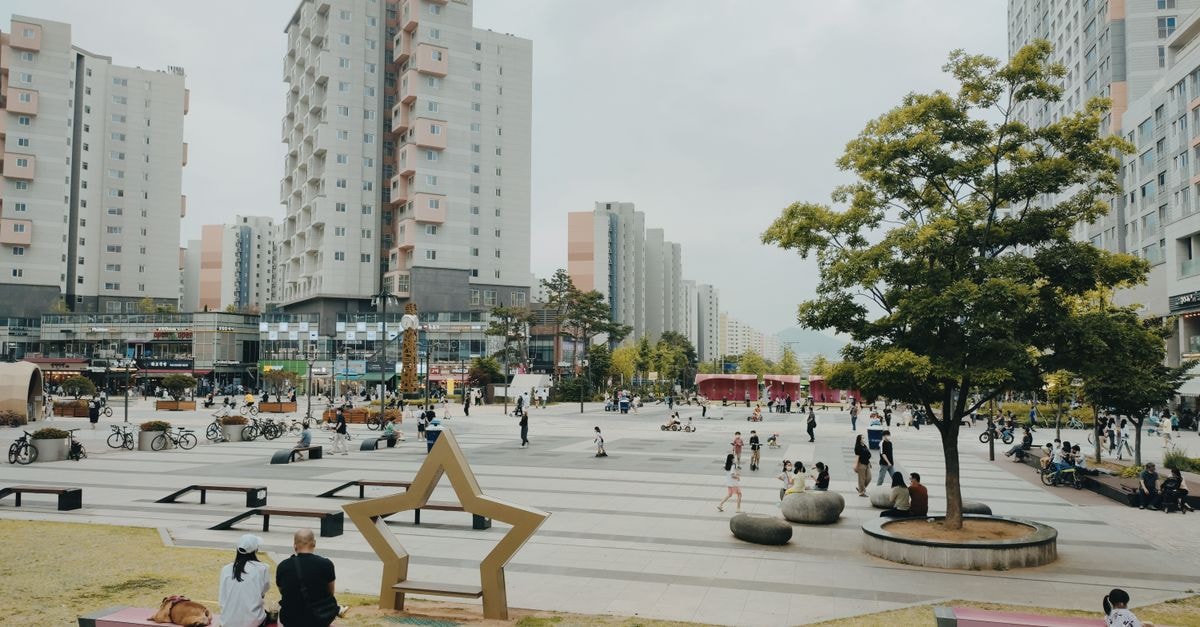 Cheongju-si Travel Guide: Tips for a Thoughtful South Korea Stop Bustling urban park in Hanam-si, South Korea with people relaxing among modern high-rise buildings.