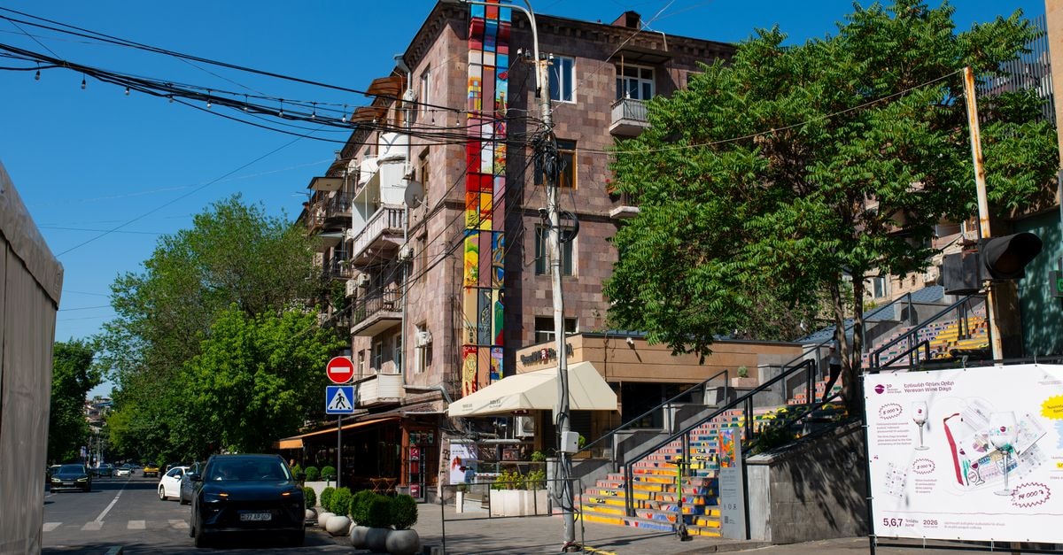 Erebuni Hotel in Yerevan: A Cozy Stay Next to Republic Square Vibrant urban street view in Yerevan featuring colorful building murals and lively atmosphere.