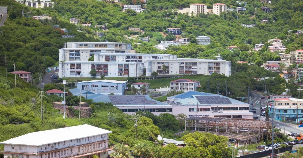 Aerial view showcasing buildings nestled in lush greenery, capturing urban life amidst nature.