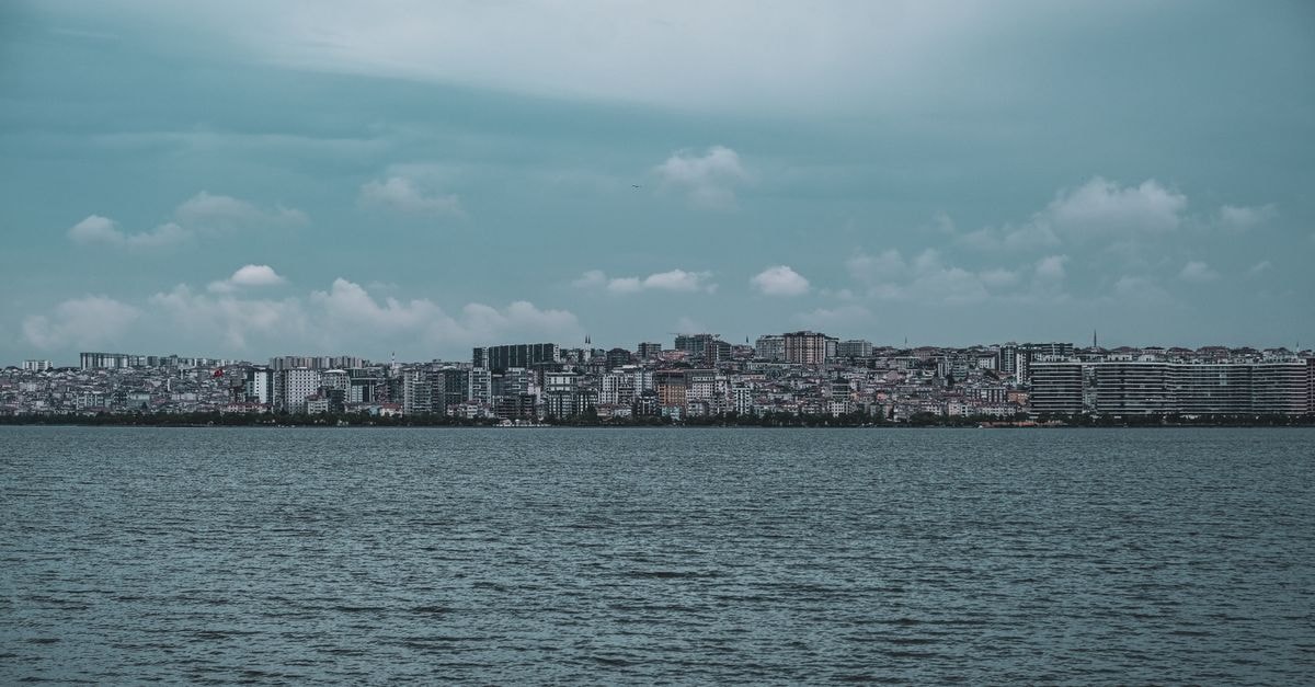 Dionissos Hotel in Larissa — Near the Ancient Theatre and City Centre Panoramic view of Istanbul's urban skyline across the sea, under a cloudy sky.