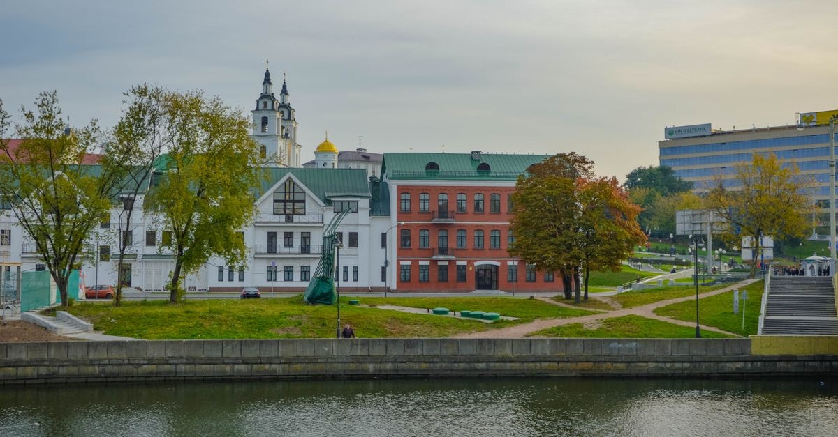 Reikartz Chernihiv: Central Stay on Hetmana Polubotka Street Charming historic architecture along a riverside in an urban park setting, showcasing vibrant fall colors.