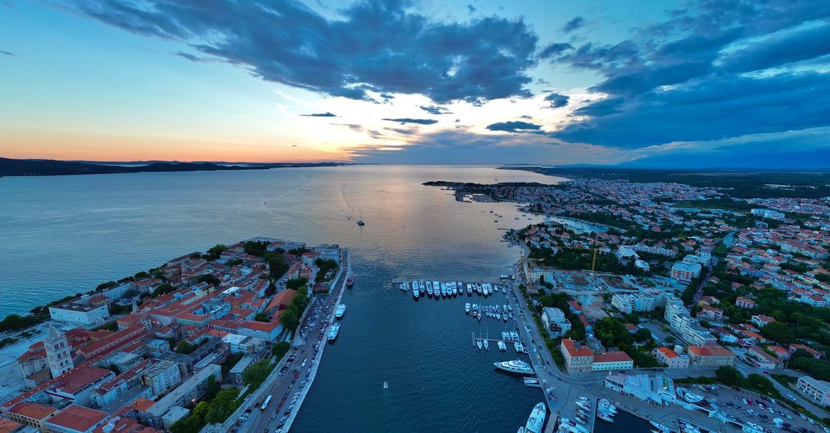 Stunning aerial capture of Zadar's picturesque harbor at sunset with vibrant skies.