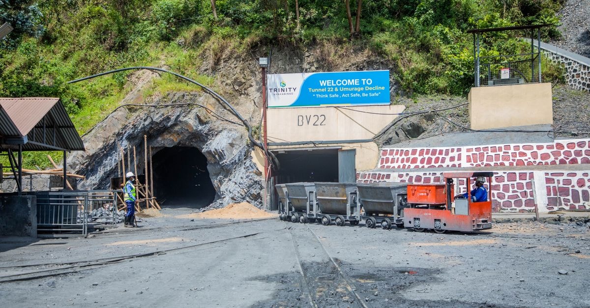 Tungsten mining update: high-grade NT assays, Trump-linked Kazakh deal scrutiny, Guardian share count Mining entrance with tunnel BV22, rail cars, and workers in safety gear at Trinity site.