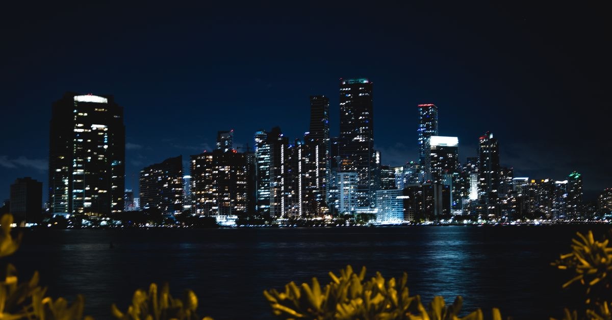 Hyatt Regency Miami in Miami: Riverwalk Art Deco Tower Steps from Brickell Captivating night view of Miami's skyline with shimmering city lights reflecting on the water.
