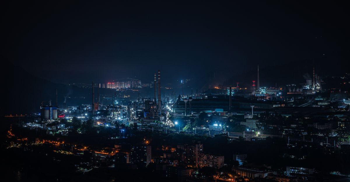 Aditya Residency in Vasai-Virar: A Stay Right by Vasai Station FOB A vibrant cityscape of industrial buildings glowing against the dark night sky.