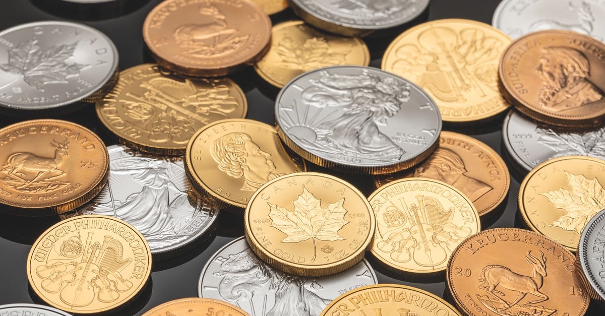 Silver rebounds as dollar weakness offsets supply concerns A detailed view of various gold and silver coins, ideal for financial themes.