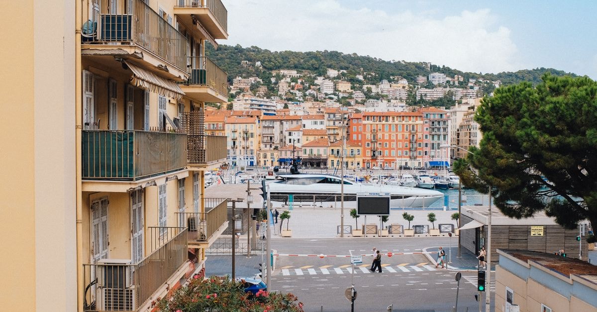 Vibrant view overlooking Nice harbor, cityscape, and hillside architecture.