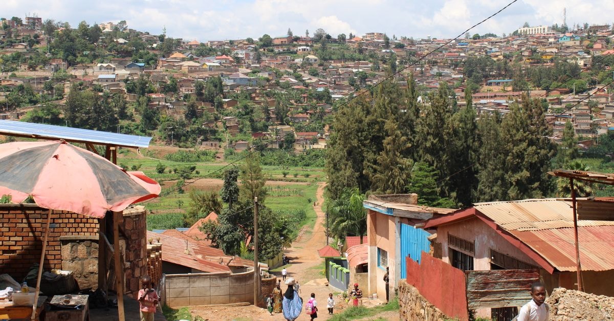 Kigali Travel Guide: Memorials, Nature and Local Flavours Captivating view of a Kigali neighborhood showcasing vibrant community life amidst lush greenery.