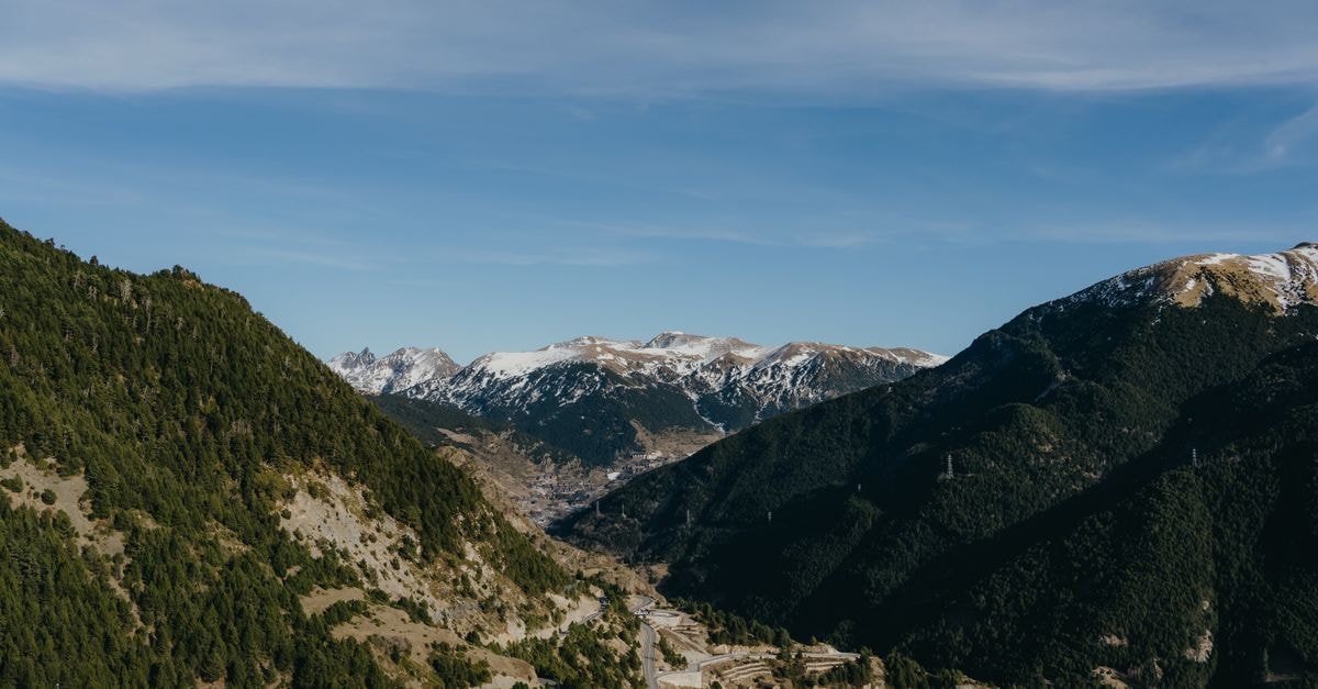 A Quiet Pocket in the Pyrenees: An Encamp Travel Guide Serpentine road winding through the majestic Pyrenees in Andorra under a clear blue sky.