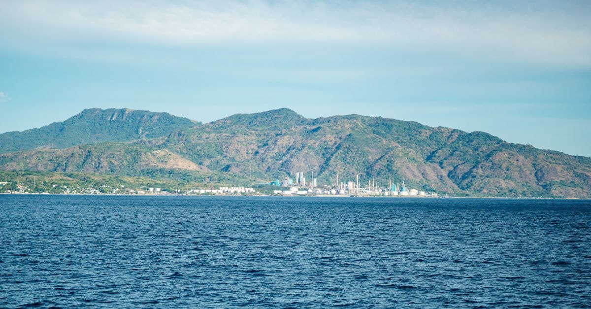 Livewire Planet Suites in General Santos: A Calm Stay Near the City Core A beautiful coastal scene with mountains in the background under a clear blue sky.