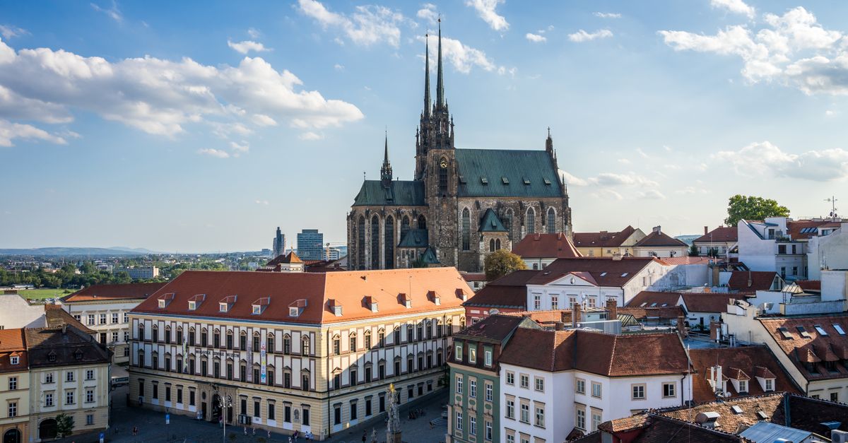 Aerial view of Brno's historic architecture with the iconic St. Peter and Paul Cathedral under a bright sky.