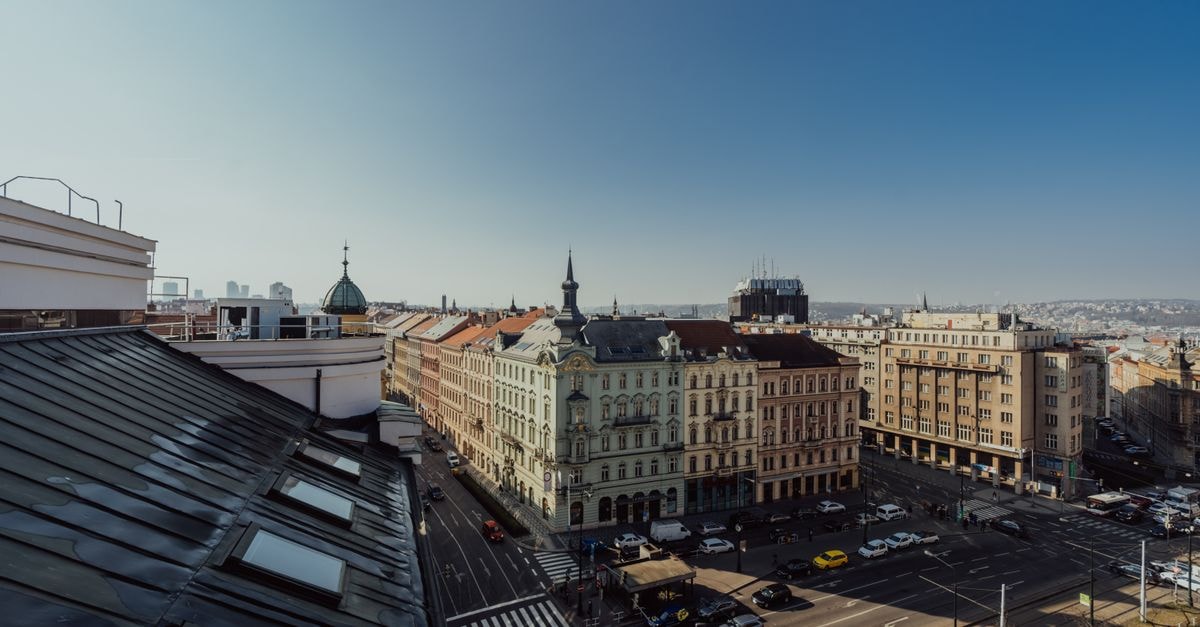 High angle view of historic architecture and streets in Prague, Czech Republic under clear blue skies.