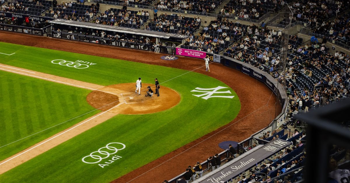 Filipina batters post first-ever Women's Baseball World Cup win, blank Cuba 6-0 Aerial view of a baseball game at Yankee Stadium with a packed crowd.