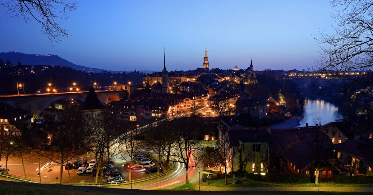 Hotel Bären, Bern — A Schauplatzgasse Stay by Bundesplatz Stunning twilight cityscape of Bern, Switzerland with the iconic Nydegg Bridge and illuminated streets.