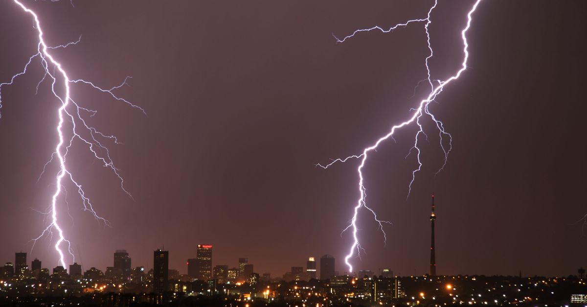 Captivating lightning strikes illuminate the Johannesburg skyline in a nighttime storm.