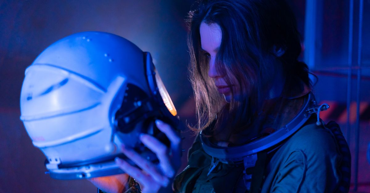 Nolan's 'The Odyssey' drives IMAX to record weekend while 70mm exclusivity fuels elitism debate A woman in a spacesuit examines an astronaut helmet under futuristic blue lighting.