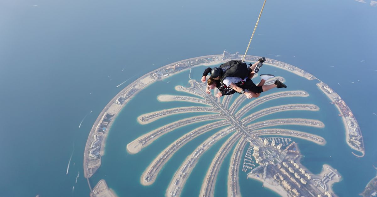 Thrilling skydiving experience over the iconic Palm Jumeirah in Dubai, offering breathtaking aerial views.