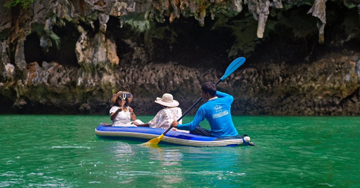 Pleven Travel Guide: Quiet Pleven Heights and a Cave Wine Stop Group kayaking through stunning limestone caves in Krabi, Thailand.
