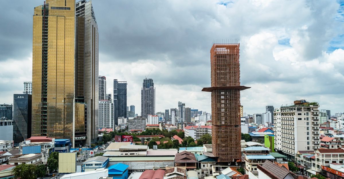 Capitol 3 in Phnom Penh: Compact Stay Near Bophana Center Aerial view of Phnom Penh featuring modern skyscrapers and urban architecture under a cloudy sky.