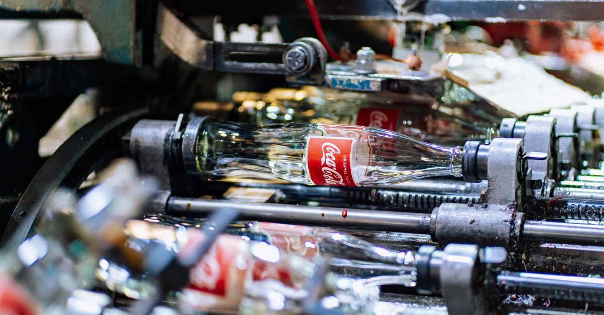 High-quality glass bottles being processed on a factory production line.