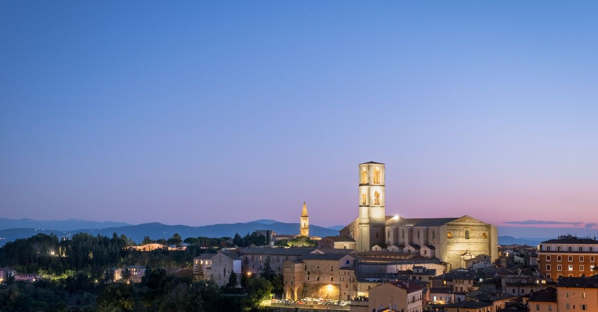 Captivating twilight cityscape of Perugia, showcasing San Domenico against a serene evening sky.