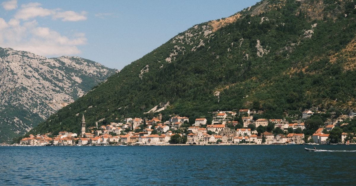 Old Town Hostel, Kotor: Sunset Barbecues Over the Bay Breathtaking view of Perast, Montenegro, featuring the Bay of Kotor and its stunning landscape.