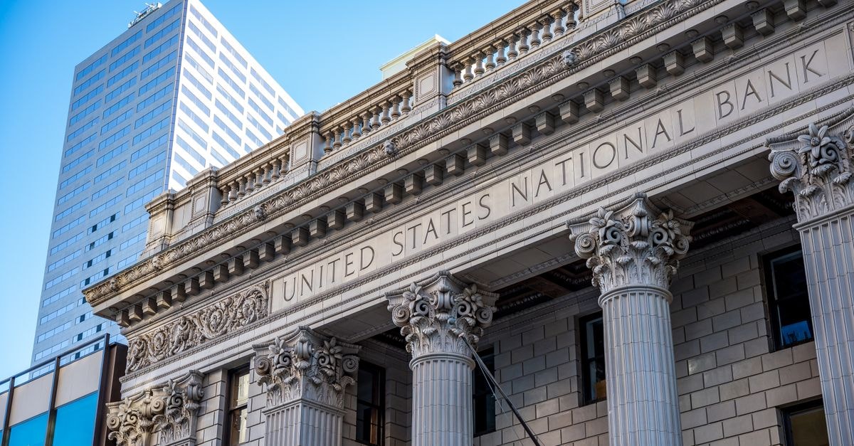 National Bank Holdings: A Western Regional Bank at a Price That Leaves Little Margin of Safety Exterior of historic national bank with decorative elements on classic columns located in city with modern building against blue sky