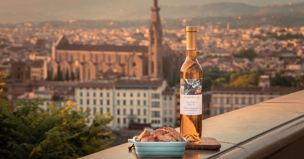 Bottle of wine and biscotti with an evening view of Florence's historic skyline.