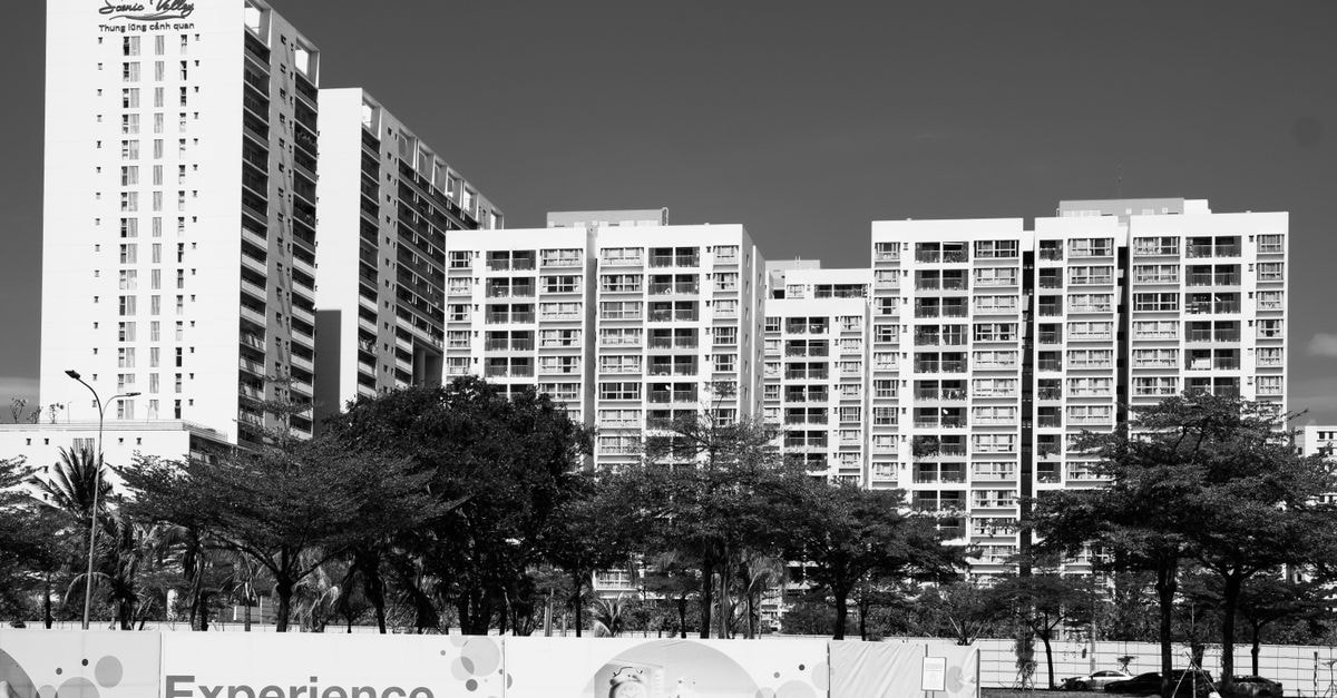 Hotel Mulia Tiza in Binjai: A Practical Stop on Jalan Medan-Binjai Contemporary high-rise apartment buildings in urban landscape, captured in grayscale.