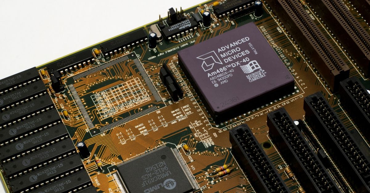 Qualcomm names Motorola's Sergio Buniac to lead new Mobile, Compute and Personal AI unit Detailed view of a vintage motherboard with an AMD microchip, showcasing intricate circuitry and slots.