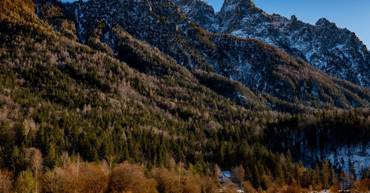 A Quiet Alpine Town: A Travel Guide to Jesenice, Slovenia Stunning winter view of Kranjska Gora's mountains and forest.