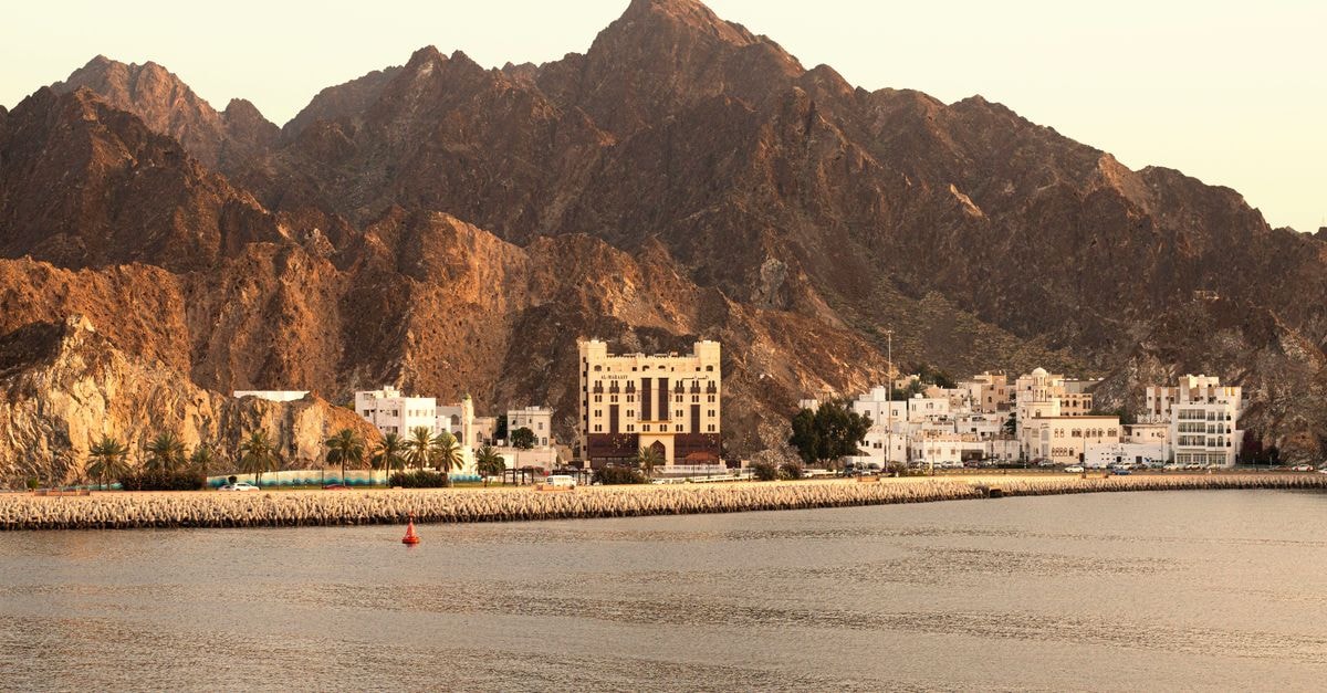 Mercure Muscat in Muscat: A Heart-of-City Stay with Heritage Design Picturesque view of Muscat's coastline with mountains and traditional architecture