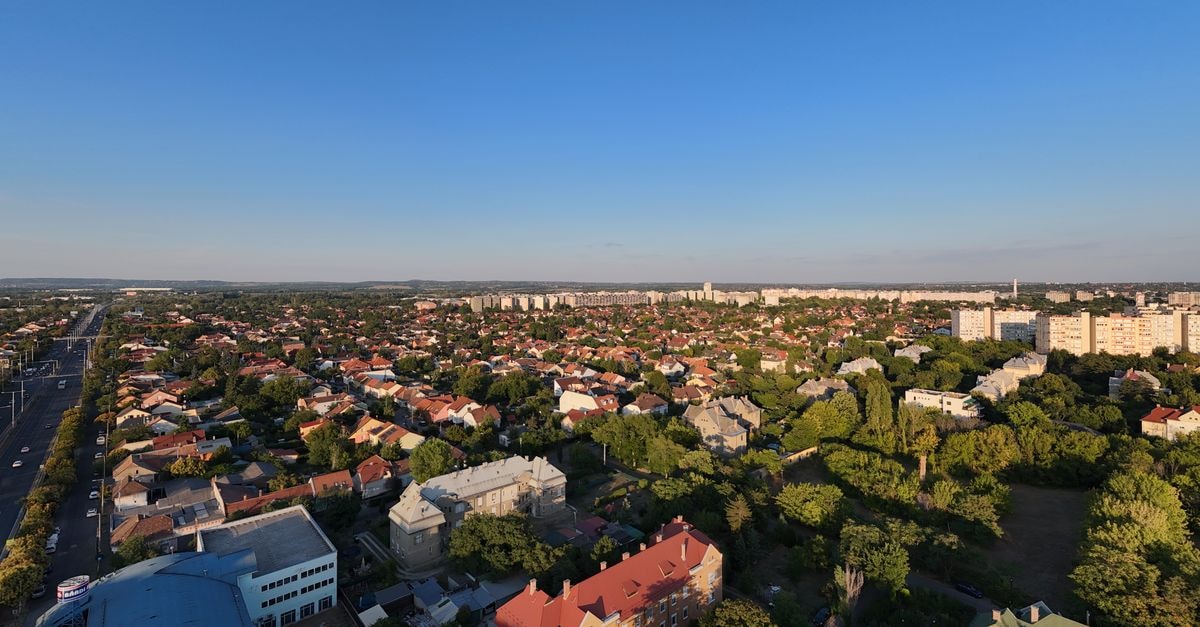 Kecskemét Travel Guide: Planning Tips, Costs and Things to Do Aerial view of a sunny urban residential neighborhood with houses and greenery.