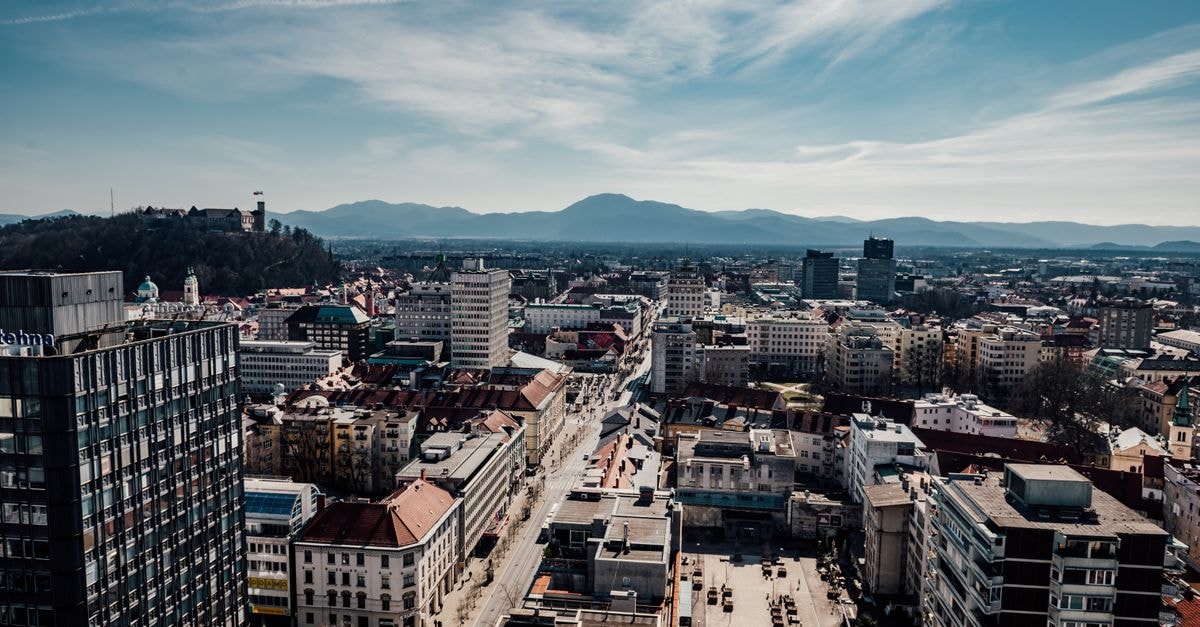 Kranj Travel Guide: Alpine Charmer Just Above Ljubljana A stunning aerial view of Ljubljana, Slovenia featuring the city's buildings, castle, and surrounding mountains.