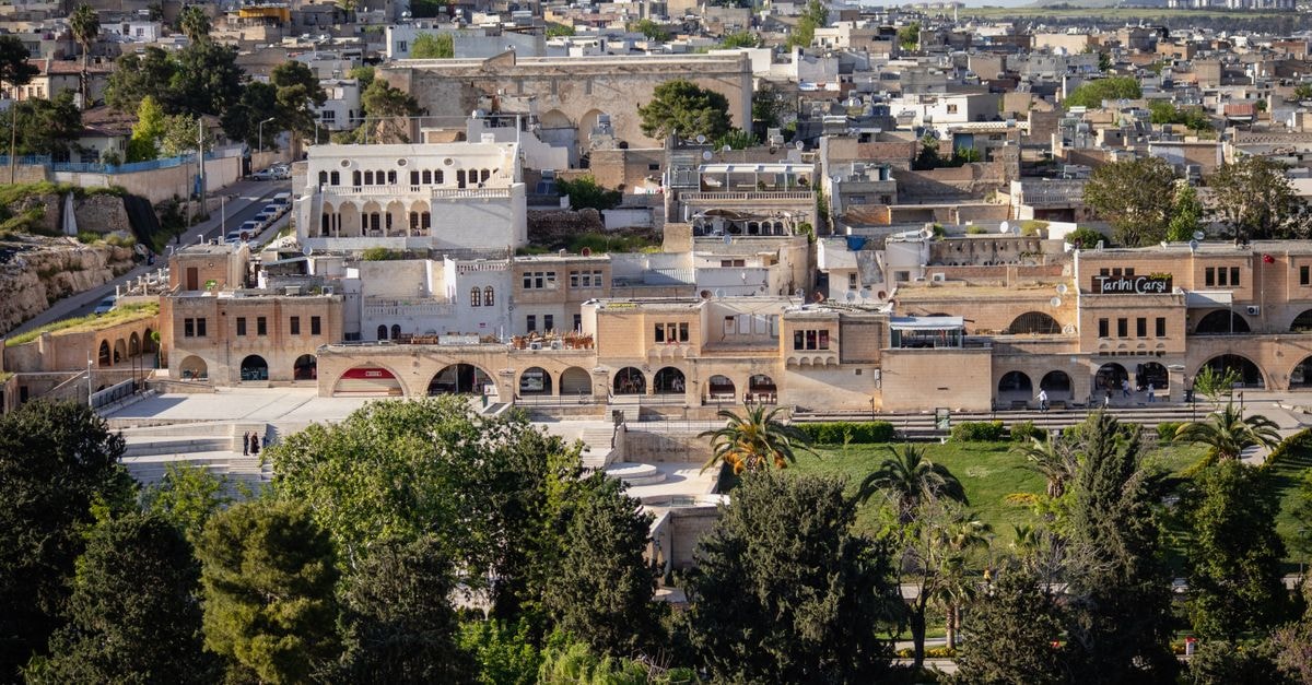 Explore the rich architectural heritage of Şanlıurfa with lush greenery in the foreground.