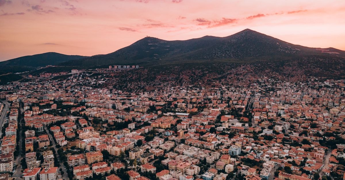 Kristeo in Vlorë: Apartment-Style Stay Near Vjetër Beach A stunning aerial view of Milas, Turkey, showcasing a vibrant residential area against a beautiful sunset sky.