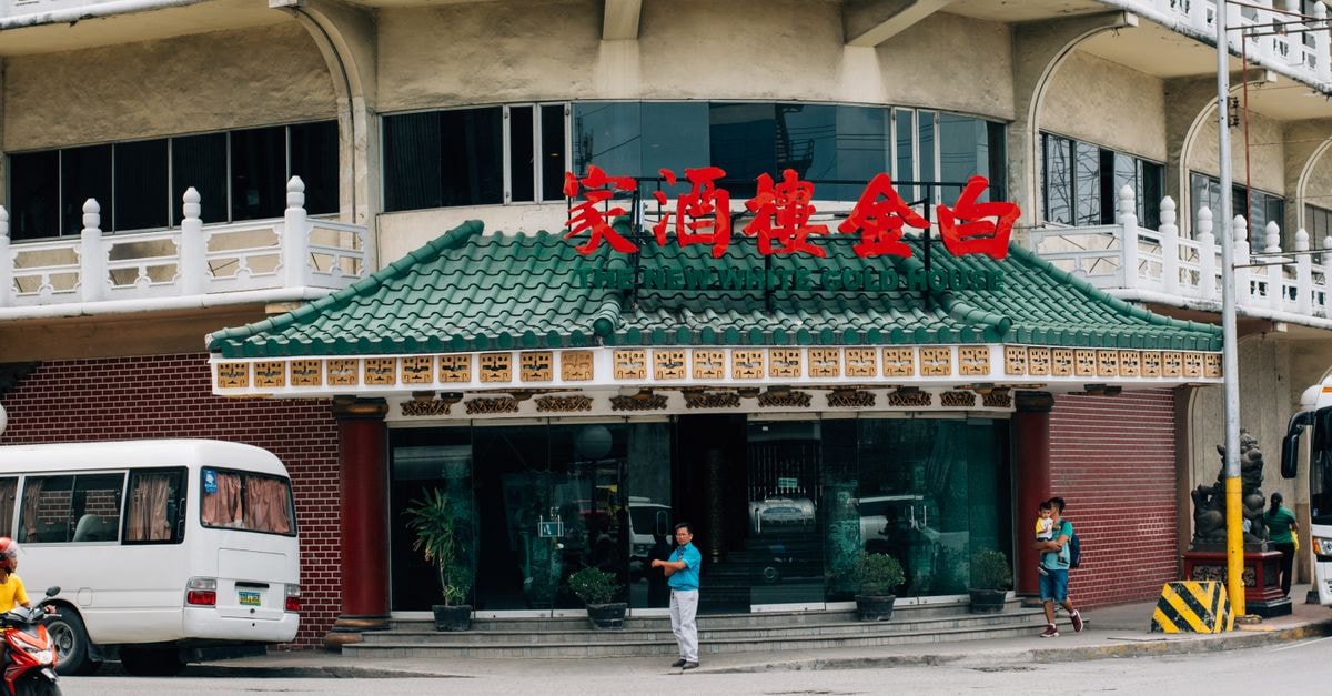 Calamba Travel Guide: Hot Springs, Heritage and an Easy Manila Escape Street view of a Chinese restaurant with green roof and red signage, capturing urban life.