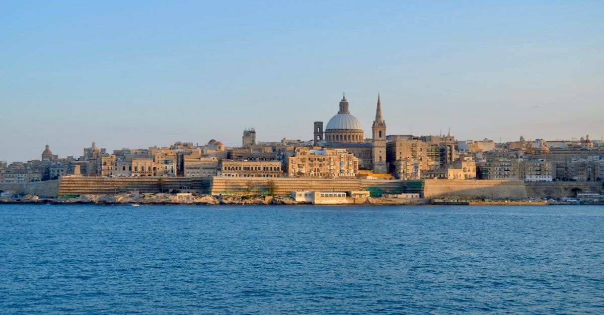 Capture of the majestic skyline of Valletta, Malta, featuring iconic architecture under a clear blue sky.