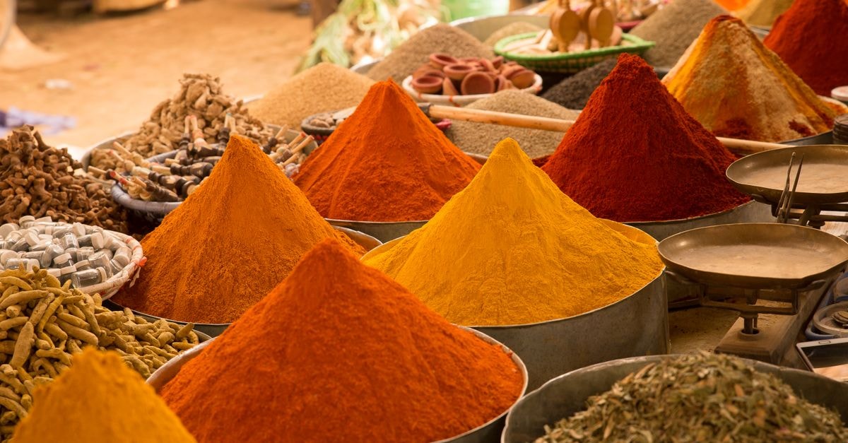 Sangli travel guide: slow days in Maharashtra's turmeric city Colorful mounds of spices on display at an outdoor street market, evoking exotic aromas.