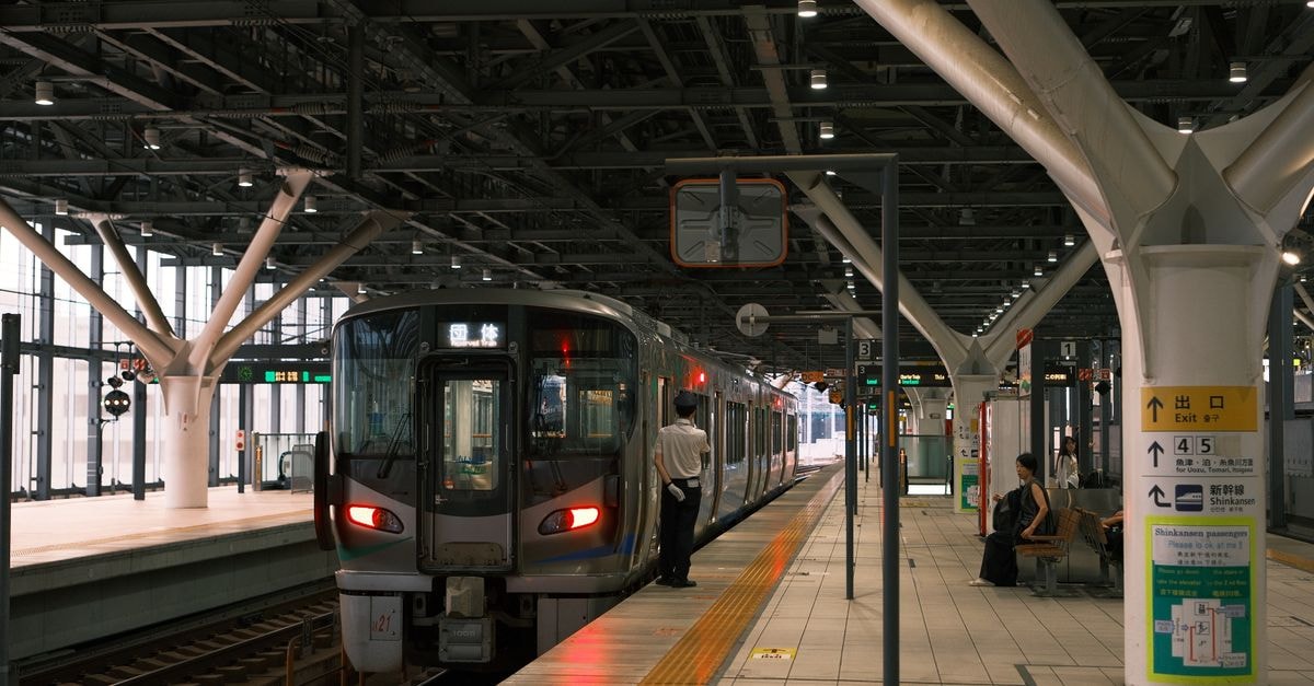 Kawasaki Travel Guide: Planning Tips, Costs and Things to Do Contemporary Japanese train station with a train waiting and passengers seated, highlighting urban commuting.