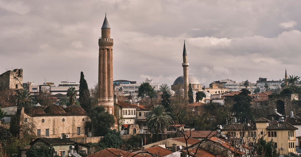 The Classic Hotel, Nicosia: Comfort in the Historic Heart Scenic view of a historic city with prominent minarets under a cloudy sky, offering a glimpse of architectural beauty.